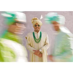 A creative motion-blur shot of the groom, making him the calm and stylish center of his vibrant baraat.