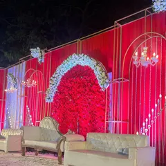 For clients who love bold statements, I designed this stunning all-red wedding stage. The combination of a dense red floral backdrop, elegant white seating, and modern gold frames creates a look of pure opulence.