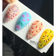 A set of four nails with colorful, hand-painted firework designs, perfect for celebrating Diwali or New Year's Eve.
