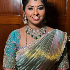 Ashritha's reception makeup. We went for a glamorous look with defined eyes, emerald green accents to match her jewellery, and a glossy nude lip.