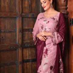 This is a lifestyle shot for a clothing brand's catalogue. Using a rustic wooden door as a backdrop adds character and context, helping customers visualize wearing the outfit.