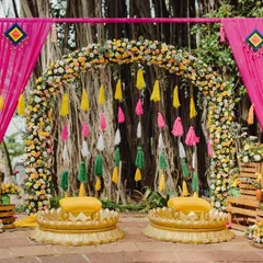 This Haldi was a carnival of colors. A vibrant floral arch and a backdrop of colorful tassels created a joyful, high-energy space for the couple to be showered with love and blessings.