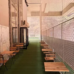 This is my Parents' Pavilion. I've set up this dedicated space with tables and chairs right next to the courts, so parents can watch their kids train, catch up on work, or simply relax.