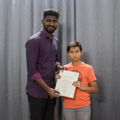 A proud moment for our student receiving his grade exam certificate. We celebrate every milestone, providing recognized certifications from boards like ABRSM and Trinity College London.