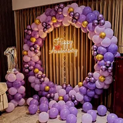 This unique purple and gold balloon arch was designed for a first anniversary. The color combination offers a stylish and less traditional option for your celebration, complete with a marquee number and neon sign.