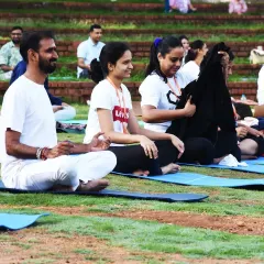 Participants enjoying a moment of rest and connection during a yoga session. Our programs offer many opportunities for Seva (volunteering), which is a beautiful way to experience transformation through service and community.