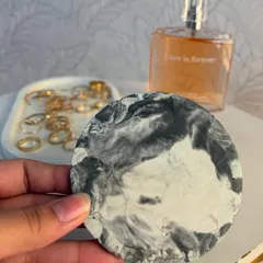 Here is my round ceramic coaster with a black and white marble effect. In the background, you can see one of my trinket trays, showing how the pieces can be styled together.