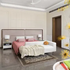 A serene bedroom in the "Ideal Home" project, featuring a soft, neutral palette with pops of pink. The elegant wall paneling and contemporary chandelier add a touch of classic luxury.