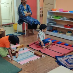 A unique aspect of our pure Montessori approach is the parent observation session. Here, a mother quietly watches her child engage in his work, gaining a true, uninterrupted window into his development and concentration in the classroom environment.