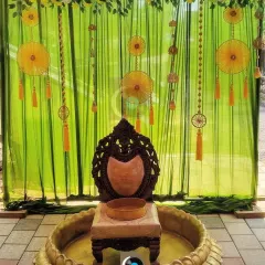 We love bringing traditions to life, like this vibrant Haldi ceremony setup. The combination of lime green drapes, marigold hangings, and a traditional brass urlu creates a festive and auspicious setting.
