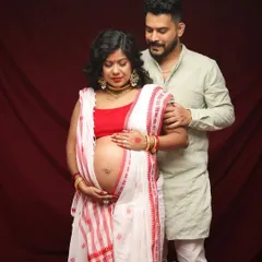 A tender moment between an expecting couple during their traditional maternity shoot. His hand on her shoulder shows his love and support on their journey.