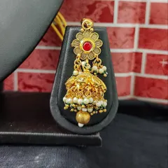 The matching earring for this set, featuring a floral top and a delicate jhumka.