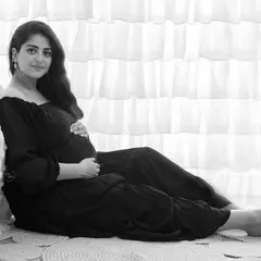 This quiet, contemplative portrait shows the beauty of black and white for solo maternity shots. The focus is entirely on the mother-to-be and the peaceful moment she is experiencing.