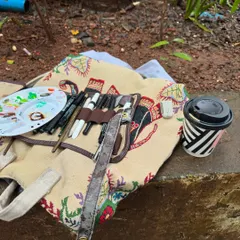 My typical setup for a day of outdoor sketching. Just my art kit, a coffee, and a good view.