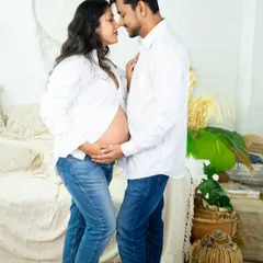 A casual and sweet moment. Dressed in matching white shirts and jeans, this couple shares an intimate nose-to-nose pose in our bright and airy studio.