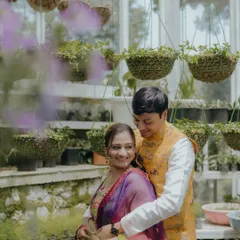 A sweet, candid moment between the couple during their Mehendi, framed by hanging plants. We find creative compositions to make your photos unique.