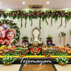From the womb to the world, every baby shower is a celebration of love. This setup features a beautiful portrait of Yashoda and Krishna, surrounded by a lush arrangement of flowers and traditional plates.