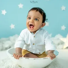 The pure delight of a sitter session. This little one's happy expression is perfectly framed by a dreamy, star-filled setup in my studio.