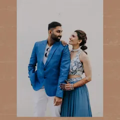 A candid and happy portrait of a couple at their carnival-themed pre-wedding party.