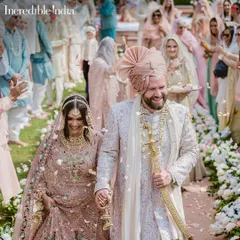 My photograph of a couple's joyful walk through a shower of petals, featured by Incredible India to promote royal weddings in Jaipur.