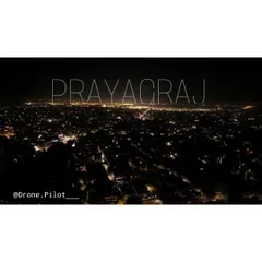 My city, Prayagraj, glowing in the dark. A simple aerial shot showing the city lights stretching out to the horizon.