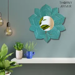 This flower-shaped wall mirror, finished in a distressed turquoise, adds a pop of color and bohemian flair. It looks wonderful styled above a shelf with small planters.