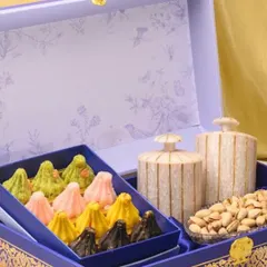 A truly royal offering for Ganesh Chaturthi. This stunning blue hamper box contains an assortment of my colourful artisanal modaks, premium pistachios, and elegant ceramic jars.