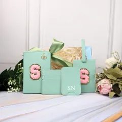 For the explorer at heart, this mint green travel combo is a perfect gift. It includes a passport holder and luggage tag with a custom initial patch, along with a card holder.