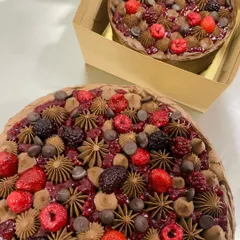 A look at my 3-berry Belgian chocolate cakes, ready to go out for delivery. They are topped with a generous amount of fresh berries, chocolate chips, and piped chocolate ganache.