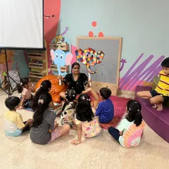 Story time with Elmer the Elephant. Using puppets makes the story interactive and helps children connect deeply with the characters and the narrative.