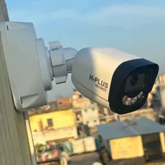 A close-up of an H-Plus Security bullet camera installed for rooftop surveillance in Ghitorni, New Delhi. Its position provides a wide, unobstructed view, perfect for monitoring large outdoor areas day and night.