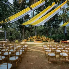 The vibrant yellow and white decor for an outdoor Haldi ceremony. This shot showcases the beautiful setup and anticipation before the guests arrive.