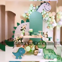 Get ready for a dino-mite party! This friendly dinosaur theme is perfect for a little one's birthday, featuring cute dino cutouts, a lush green color scheme, and a multi-level display for cakes and treats.