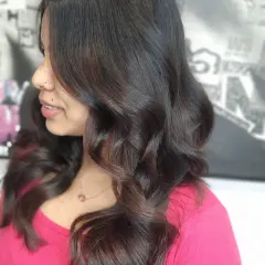 A side profile of the face-framing layers, showing how they gently curve to flatter the client's features.
