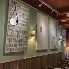 An installation of three large 6ft x 3ft minimalist canvases at Sidewalk cafe. Each piece explores a different abstract concept using a simple black and white palette, creating a cohesive and stylish gallery wall.