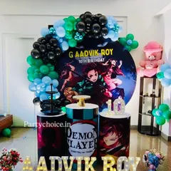 A Demon Slayer anime theme for a 10th birthday. We used a dark and dramatic color palette with a circular character backdrop, themed pedestals, and the birthday boy's name in light-up letters.