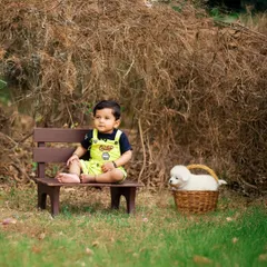 A boy and his furry friend. This heartwarming outdoor portrait captures a gentle moment with a puppy, adding an extra layer of sweetness to the photoshoot.