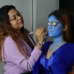 A behind-the-scenes look at creating a fantasy character. Here, I am carefully painting intricate details for this blue-skinned mystical being, using professional-grade body paints for a seamless finish.
