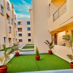 This apartment balcony was converted into a lush, green retreat. I used high-quality artificial turf for the flooring and added potted faux palm plants to create a maintenance-free garden space that can be enjoyed all year round, perfect for city living.