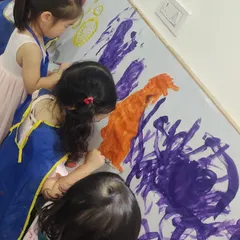 Children get to work on a large canvas together, painting with focus and imagination. This kind of free-form abstract art allows them to express their feelings and ideas without limits.