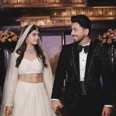 A candid shot of the couple sharing a happy glance as they walk hand-in-hand. This captures the joy and connection during a formal evening event.