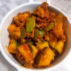 This Ambi Hari Mirchi pickle is a new favorite. It combines the tang of raw mango (ambi) with the mild heat of green chilies. It has become a bestseller for its unique spicy and sour flavour.