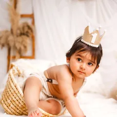A curious crawl. This action shot captures the exploratory nature of a one-year-old, even in a calm, minimalist setting.