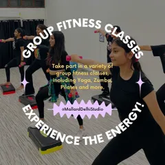 Experience the energy of our group fitness classes. This image captures a moment from our stepper workout, where members use aerobic steps and dumbbells to intensify their cardio and build muscle.