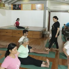 A glimpse into healing in action. Here I am walking through the class, observing and guiding students in Dandasana (Staff Pose). This personal attention is what ensures every student is on the right path.