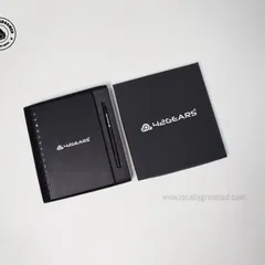 A classic and professional gift set for 42Gears. This includes a black spiral notebook and a matching pen, presented in a sleek box with the company's logo prominently displayed.