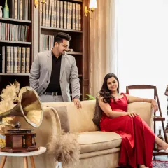 A candid moment in the library, where the groom looks lovingly at his bride. The vintage gramophone and bookshelves add a touch of old-world charm to this pre-wedding photo.