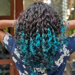 Who says you can't have fun with color? This vibrant turquoise dip-dye adds a playful pop of personality while keeping the roots natural and the curls healthy and defined.