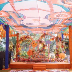 A 'Mexican Fiesta' themed Mehendi. The decor is bursting with color, from the floral arrangements to the custom printed ceiling and quirky seating.