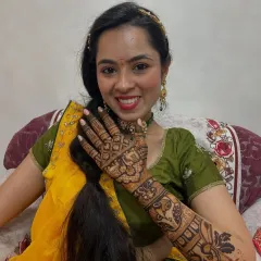 A smiling client happy with her bridal mehndi. Her design features animal motifs and traditional patterns, and the dark color is guaranteed with my organic henna.